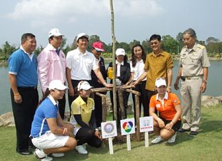 Golfers, sponsors and promoters pose for a commemorative photo during the tree planting event.
